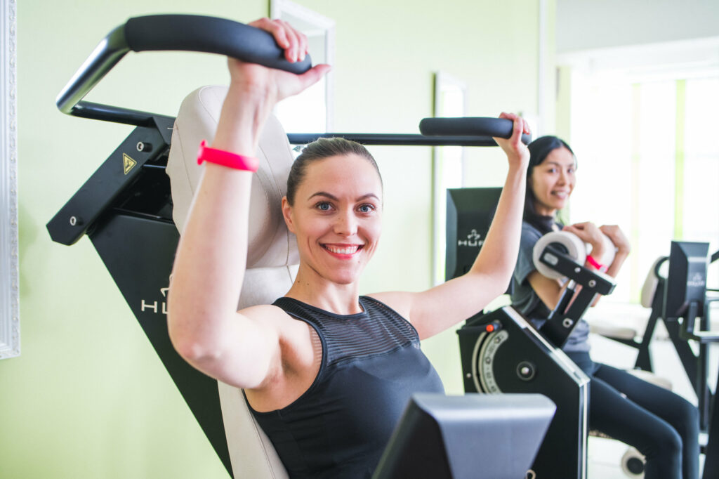 Two women training with HUR gym machines.