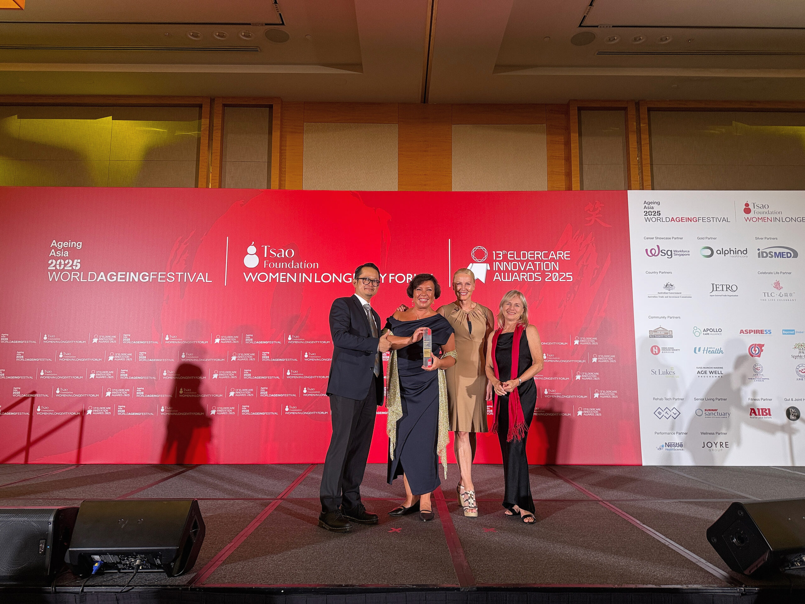 Four individuals posing with an award, celebrating the HUR Mobile App's 'Innovation of the Year' win at the World Ageing Festival 2025.